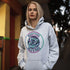 Featuring a stunning graphic of a majestic snowy owl in flight, set against the glowing northern lights, this hoodie embodies the freedom and grace of the province’s untamed wilderness.